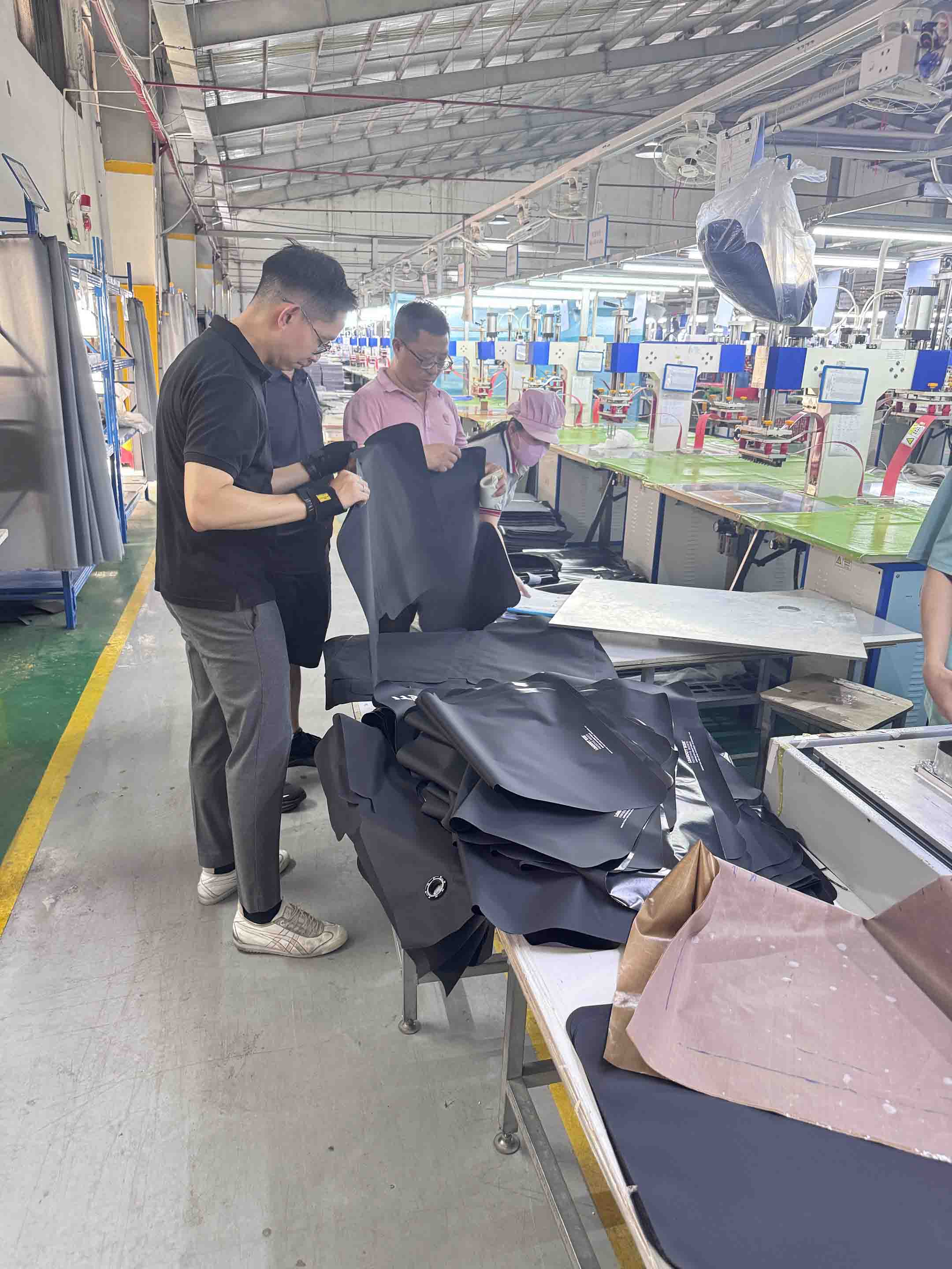 YETI team at the high-frequency welding station reviewing the cooler bag sealing process